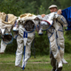FOR USE AS DESIRED, YEAR END PHOTOS - FILE - An employee of the Russian Space Training Center hangs out space suits to dry of Russian cosmonaut Anatoly Ivanishin, NASA's U.S. flight engineer Kathleen Rubins and Japanese space agency's flight engineer Takuya Onishi after their undergoing training near in Noginsk, 60 km (38 miles) east of Moscow, Russia, Wednesday, July 2, 2014. The training was intended to simulate the capsule landing on water.